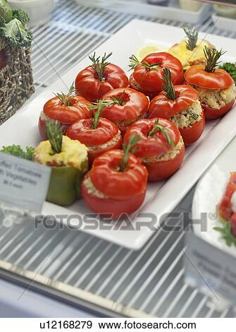 Stock Photo - Close-up of stuffed tomatoes in serving dish. Fotosearch