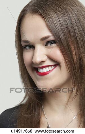 Close-up portrait of a beautiful woman with red lips smiling over gray background View Large Photo Image Stock Photo - Close-up portrait of a beautiful woman with red lips smiling over gray background. Fotosearch