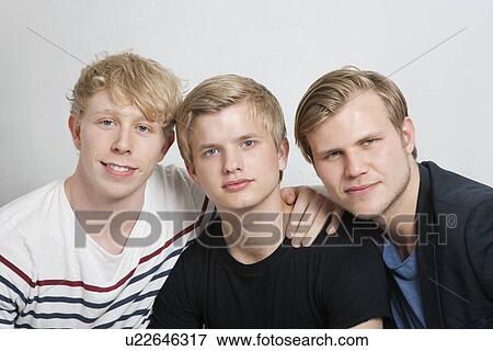 Stock Photo - Close-up portrait of three young male friends. Fotosearch