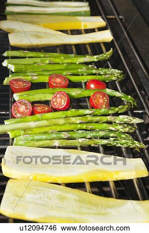 Stock Photograph - Cucumber, tomatoes and asparagus on grill. Fotosearch