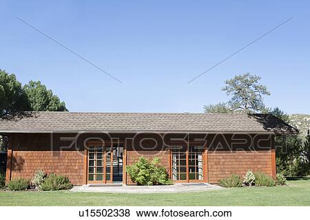 Exterior of a country house and lawn against clear blue sky View Large Photo Image Stock Photo - Exterior of a country house and lawn against clear blue sky. Fotosearch