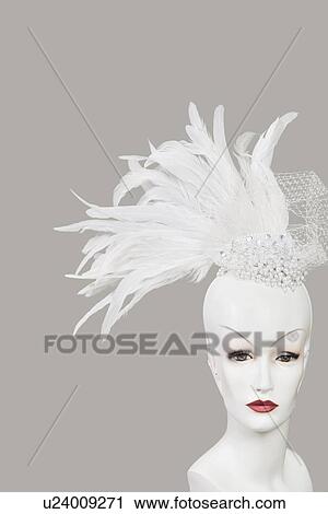 Feather fascinator on mannequin against gray background View Large Photo Image Stock Image - Feather fascinator on mannequin against gray background. Fotosearch