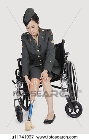 Female US military officer in wheelchair fitting prosthesis foot over gray backgrounds View Large Photo Image Stock Photo - Female US military officer in wheelchair fitting prosthesis foot over gray backgrounds. Fotosearch