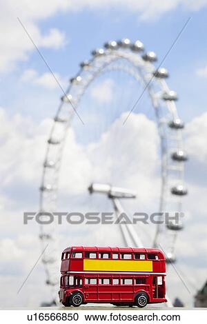Figurine of double-decker bus with London Eye in the background View Large Photo Image Stock Image - Figurine of double-decker bus with London Eye in the background. Fotosearch