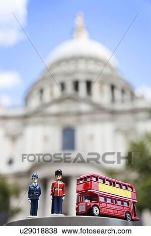Stock Photo - Figurines of London officers and double-decker bus with St. Paul's Cathedral in background. Fotosearch