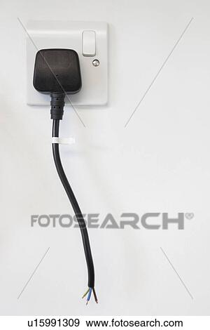 Frayed electrical cord with outlet attached on white wall View Large Photo Image Stock Photo - Frayed electrical cord with outlet attached on white wall. Fotosearch