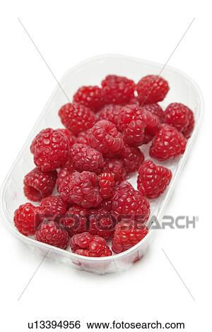 Stock Photograph - Fresh raspberries in a container against white background. Fotosearch