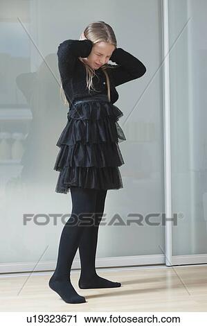 Frustrated young girl in black clothing covering ears View Large Photo Image Stock Image - Frustrated young girl in black clothing covering ears. Fotosearch