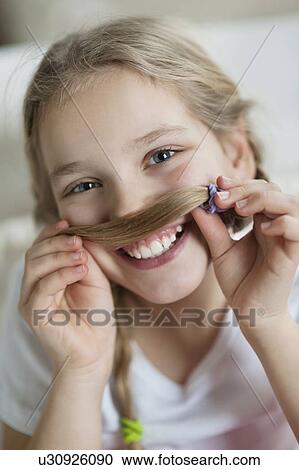Girl making mustache with hair View Large Photo Image Stock Image - Girl making mustache with hair. Fotosearch