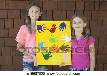 Girls showing colorful multiple hand prints against brick wall View Large Photo Image Stock Image - Girls showing colorful multiple hand prints against brick wall. Fotosearch