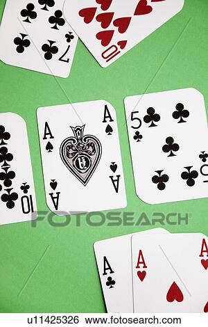 Stock Photograph - High angle view of a playing cards on green surface. Fotosearch