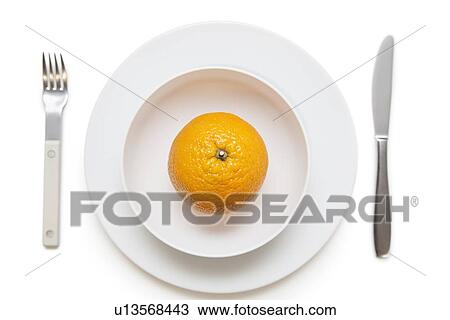 High angle view of an orange in dish with fork and knife over white background View Large Photo Image Stock Image - High angle view of an orange in dish with fork and knife over white background. Fotosearch