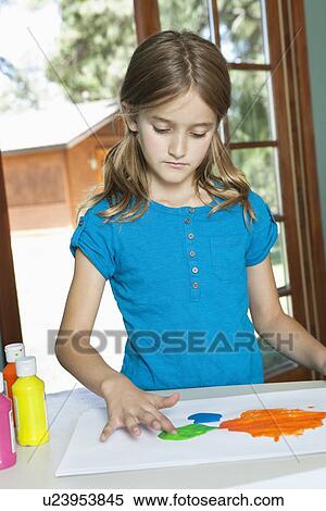 Little girl finger painting on paper at table View Large Photo Image Stock Photography - Little girl finger painting on paper at table. Fotosearch