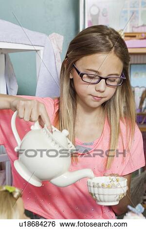 Little girl playing with tea set View Large Photo Image Stock Photograph - Little girl playing with tea set. Fotosearch