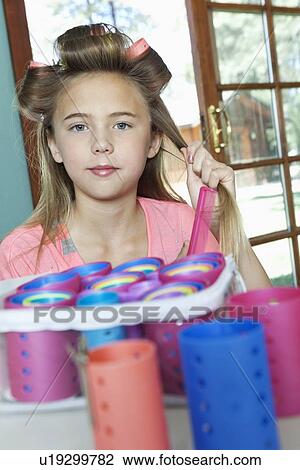 Little girl putting rollers in hair View Large Photo Image Stock Image - Little girl putting rollers in hair. Fotosearch