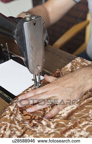 Male tailor stitching cloth on sewing machine View Large Photo Image Stock Photograph - Male tailor stitching cloth on sewing machine. Fotosearch