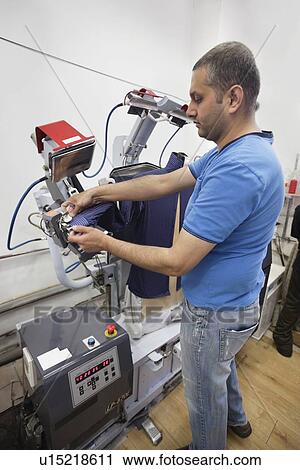 Man adjusting shirt on laundry dummy machine at launderette View Large Photo Image Stock Image - Man adjusting shirt on laundry dummy machine at launderette. Fotosearch