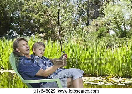 Man and son fishing together countryside View Large Photo Image Stock Photo - Man and son fishing together countryside. Fotosearch