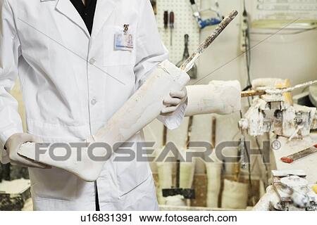 Mid section of a male technician with prosthetic foot View Large Photo Image Stock Image - Mid section of a male technician with prosthetic foot. Fotosearch