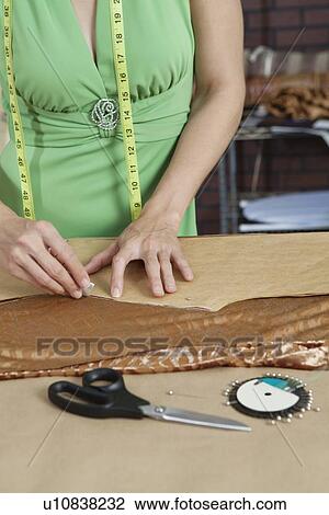 Midsection of female tailor marking pattern with chalk on fabric View Large Photo Image Stock Image - Midsection of female tailor marking pattern with chalk on fabric. Fotosearch