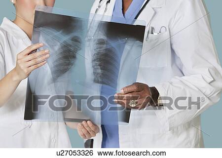 Midsection of health care professionals analyzing x-ray report View Large Photo Image Stock Photograph - Midsection of health care professionals analyzing x-ray report. Fotosearch
