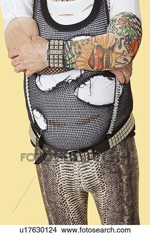 Midsection of senior man standing with arms crossed over yellow background View Large Photo Image Picture - Midsection of senior man standing with arms crossed over yellow background. Fotosearch