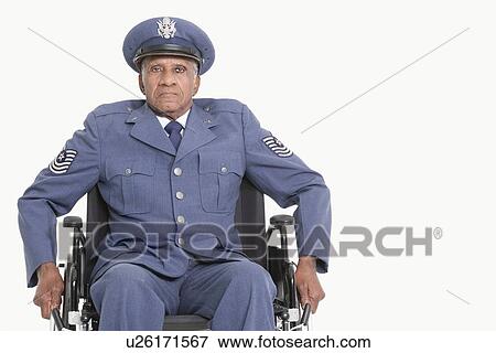 Stock Photo - Portrait of a disabled senior male US Air Force officer in wheelchair over gray background. Fotosearch