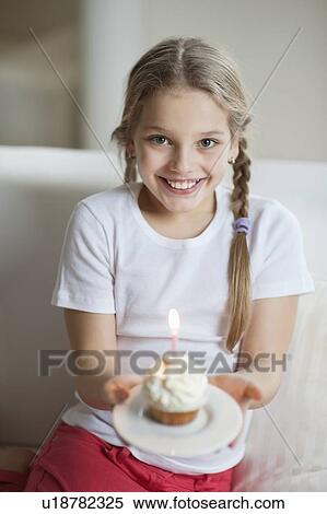 Portrait of a girl with cupcake View Large Photo Image Stock Photography - Portrait of a girl with cupcake. Fotosearch