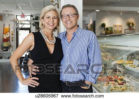 Portrait of a happy mature couple at cafeteria View Large Photo Image Stock Photo - Portrait of a happy mature couple at cafeteria. Fotosearch