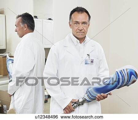Stock Photograph - Portrait of a mature technician with advanced prosthetic foot. Fotosearch