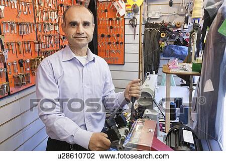 Stock Image - Portrait of a senior male owner of key store. Fotosearch