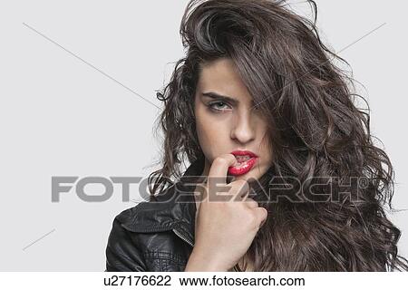 Portrait of a sensuous young woman over gray background View Large Photo Image Stock Image - Portrait of a sensuous young woman over gray background. Fotosearch