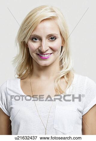 Portrait of beautiful Caucasian woman smiling over gray background View Large Photo Image Stock Photo - Portrait of beautiful Caucasian woman smiling over gray background. Fotosearch
