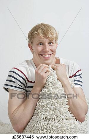 Portrait of excited young man holding fur blanket View Large Photo Image Stock Photography - Portrait of excited young man holding fur blanket. Fotosearch