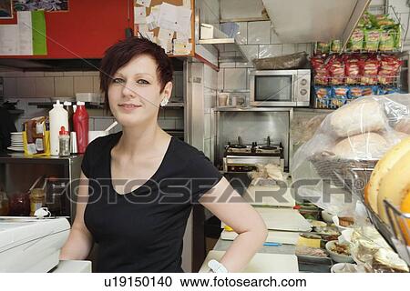 Portrait of female cafe owner smiling View Large Photo Image Stock Image - Portrait of female cafe owner smiling. Fotosearch