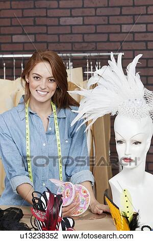 Stock Image - Portrait of happy female dressmaker at design studio. Fotosearch