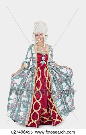 Stock Photography - Portrait of happy senior queen standing over gray background. Fotosearch