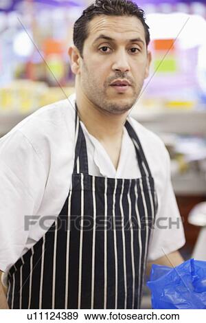 Portrait of male butcher wearing apron View Large Photo Image Stock Photo - Portrait of male butcher wearing apron. Fotosearch