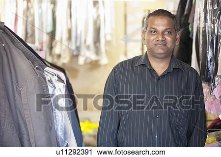 Stock Image - Portrait of male Laundromat owner. Fotosearch