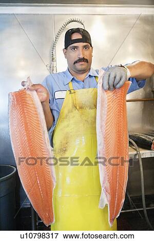 Portrait of mature fishmonger holding sliced salmon View Large Photo Image Stock Photo - Portrait of mature fishmonger holding sliced salmon. Fotosearch