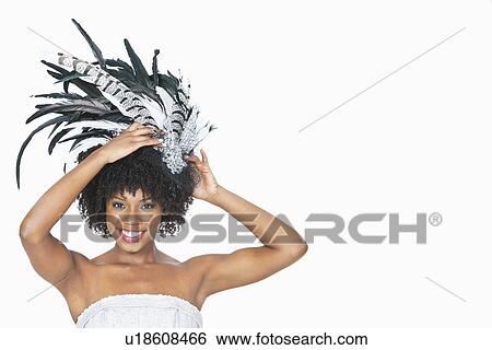 Portrait of pretty African American bride wearing feather fascinator over gray background View Large Photo Image Stock Photograph - Portrait of pretty African American bride wearing feather fascinator over gray background. Fotosearch