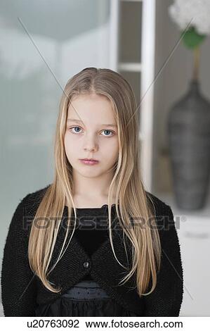 Stock Image - Portrait of sad young girl with long blond hair. Fotosearch
