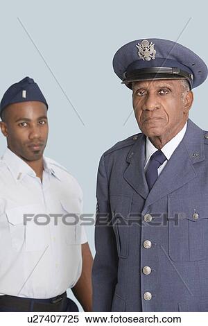Portrait of senior US Air Force officer with male cadet over light blue background View Large Photo Image Stock Photography - Portrait of senior US Air Force officer with male cadet over light blue background. Fotosearch