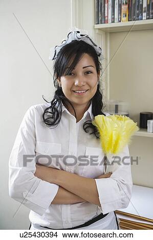 Portrait of young maidservant holding feather duster View Large Photo Image Picture - Portrait of young maidservant holding feather duster. Fotosearch
