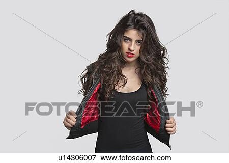 Stock Photo - Portrait of young woman in stylish outfit over gray background. Fotosearch