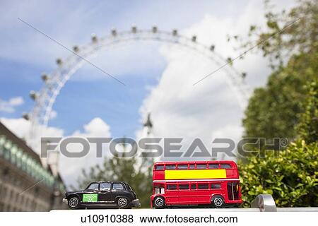 Stock Photo - Public transport figurines with London Eye in the background. Fotosearch