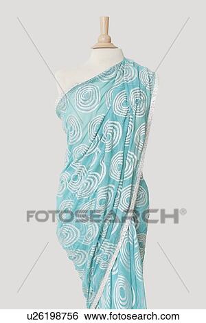 Stock Photograph - Sari draped on tailor's dummy against gray background. Fotosearch