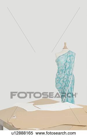 Sari draped on tailor's dummy with cardboard cuttings on table View Large Photo Image Stock Photography - Sari draped on tailor's dummy with cardboard cuttings on table. Fotosearch