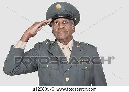 Senior male US military officer saluting over gray background View Large Photo Image Stock Image - Senior male US military officer saluting over gray background. Fotosearch