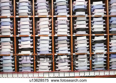 Shirts and hand cuff links displayed on shelves View Large Photo Image Stock Photography - Shirts and hand cuff links displayed on shelves. Fotosearch
